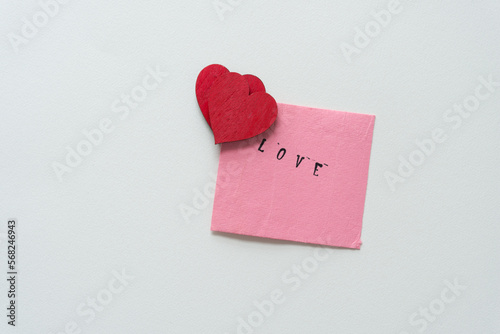wooden hearts and pink note with the word love 