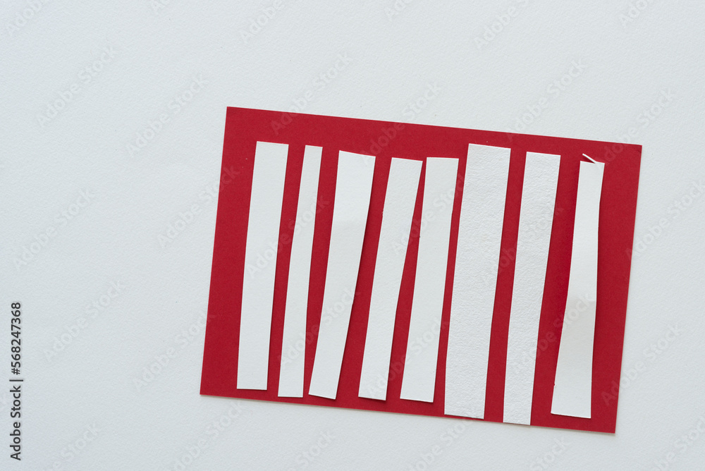 short white paper stripes on red paper card short white paper stripes on red paper card