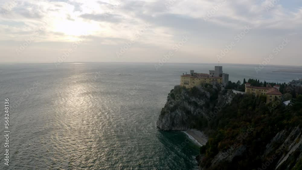 aerial drone shot of duino castle near trieste italy in sunset aerial drone shot of duino castle near trieste italy in sunset