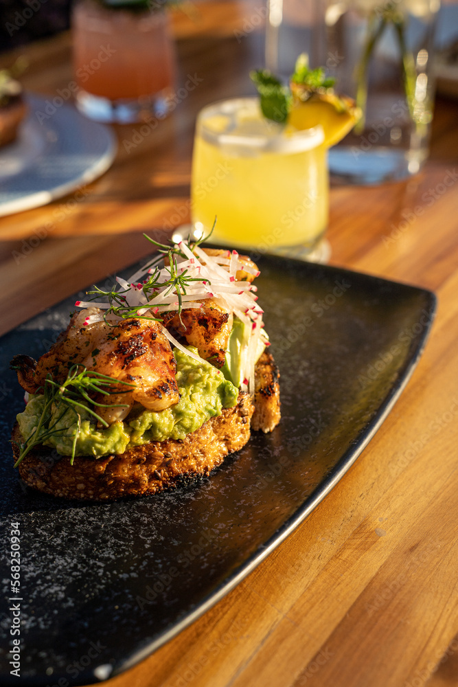 Shrimp Avocado Toast on black plate during daytime Shrimp Avocado Toast on black plate during daytime