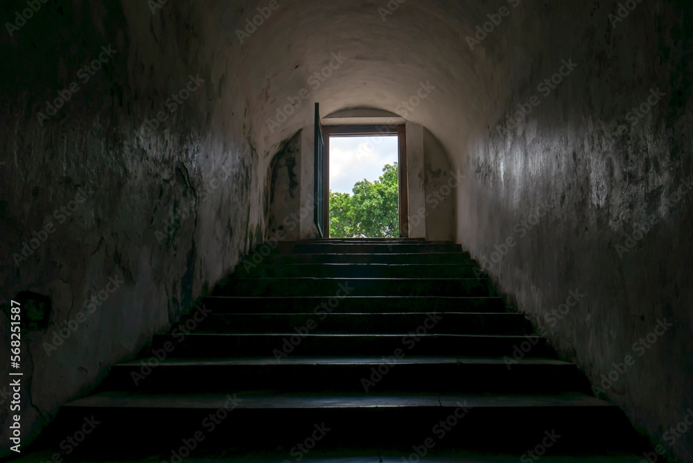 Entrance with dark staircase to underground tunnel connecting inside Tamansari water castle in Yogyakarta, Indonesia Entrance with dark staircase to underground tunnel connecting inside Tamansari water castle in Yogyakarta, Indonesia