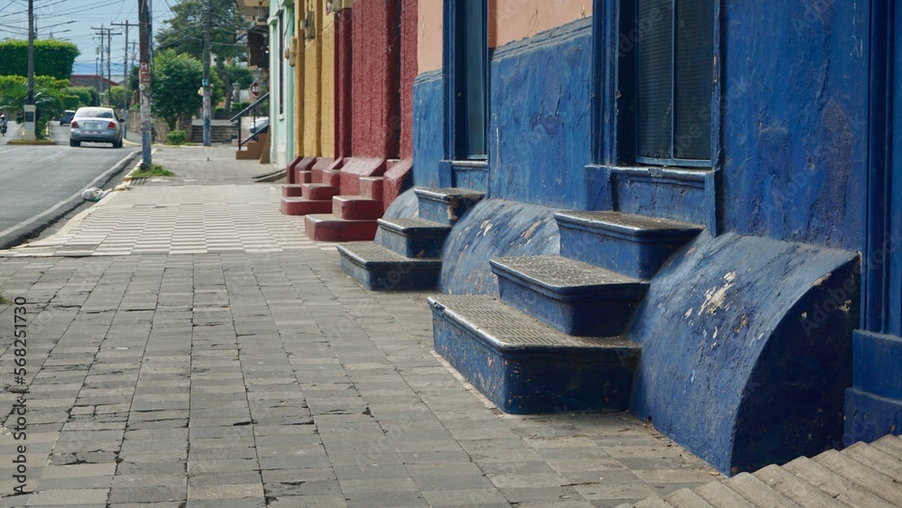 Row of small, colorful stairs along a street of the colonial city of Granada, Nicaragua. Row of small, colorful stairs along a street of the colonial city of Granada, Nicaragua.