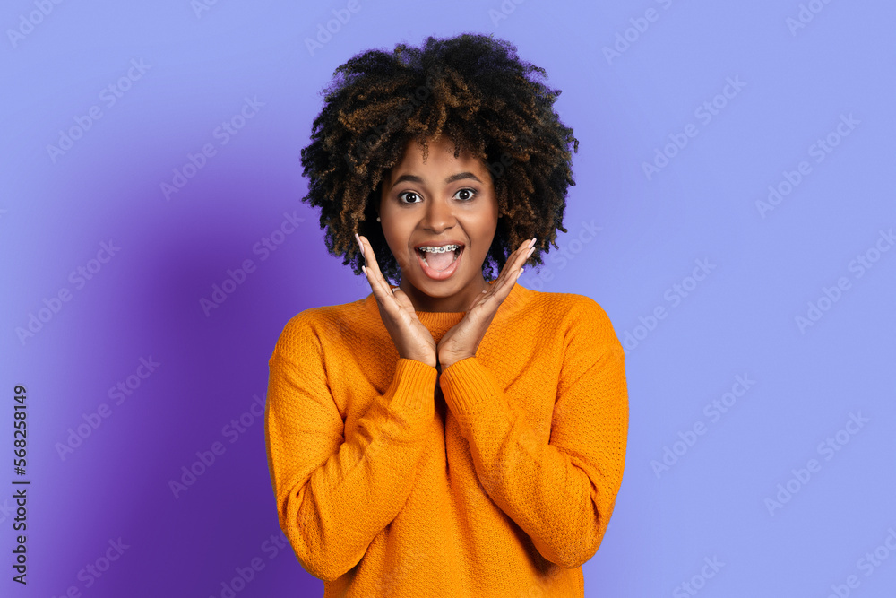 Surprised emotional young black woman looking at camera Surprised emotional young black woman looking at camera