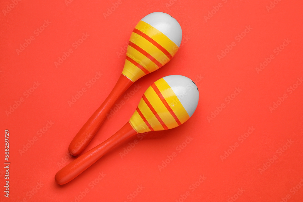 Maracas on red background, top view. Musical instrument Maracas on red background, top view. Musical instrument