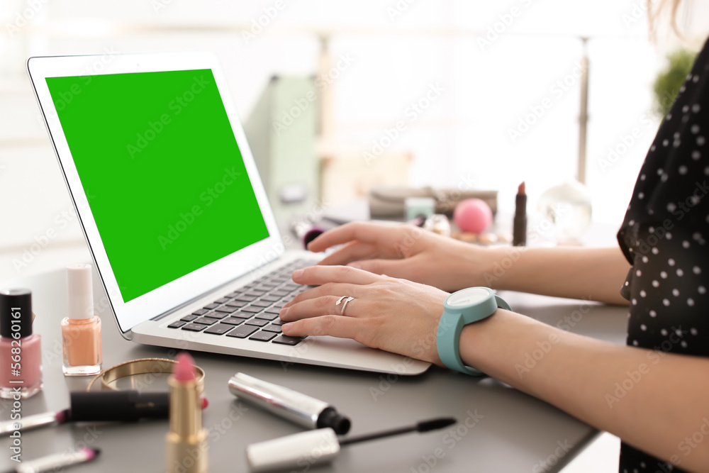 Young woman using laptop at desk, closeup. Device display with chroma key Young woman using laptop at desk, closeup. Device display with chroma key