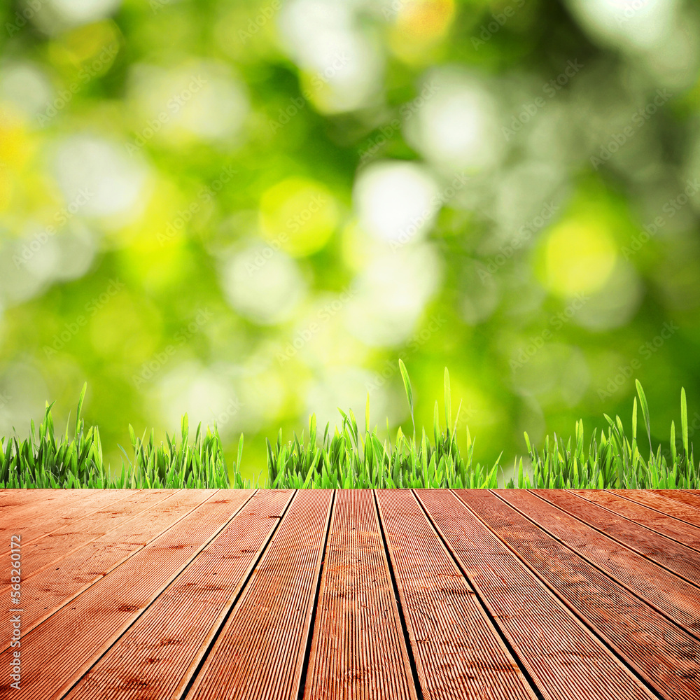 Spring season. Empty wooden surface near fresh green grass