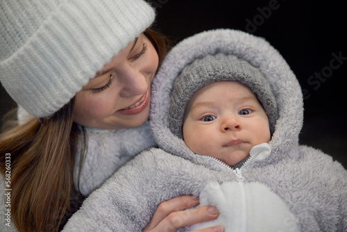 Close-up portrait of a 3-month-old baby, dressed in warm clothes for a walk on the street. Handsome baby.