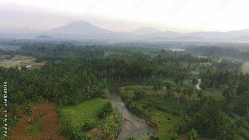 Aerial view, drone flying over a river, tropical rural scenery Aerial view, drone flying over a river, tropical rural scenery