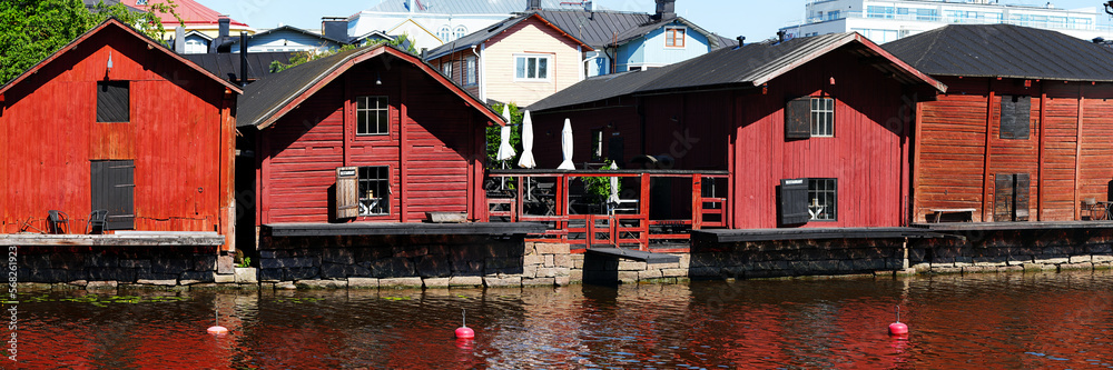 Red harbor warehouses with nice reflections on porvoo river. fishing village in scandinavian style. houses painted in swedish red