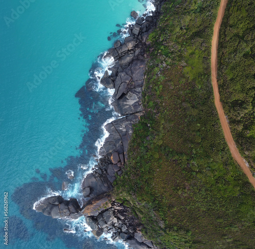 Amazing aerial View of the coast of Shelleys beach with blue sea, green trees and red gravel road in Albany, Western Australia