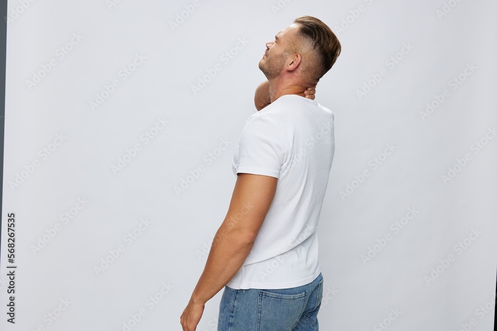 Man back pain neck and joints, bone and spine problems, inflammation and trauma, in white T-shirt on white isolated background, copy space Man back pain neck and joints, bone and spine problems, inflammation and trauma, in white T-shirt on white isolated background, copy space