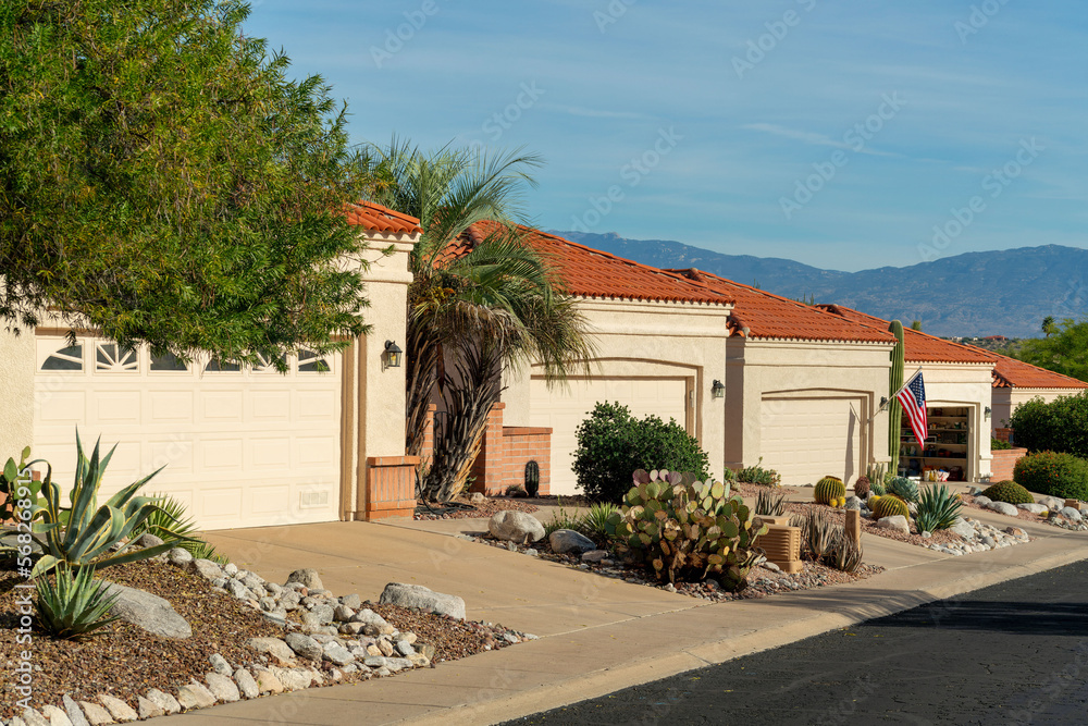 Row of modern adobe style one story houses in desert community of