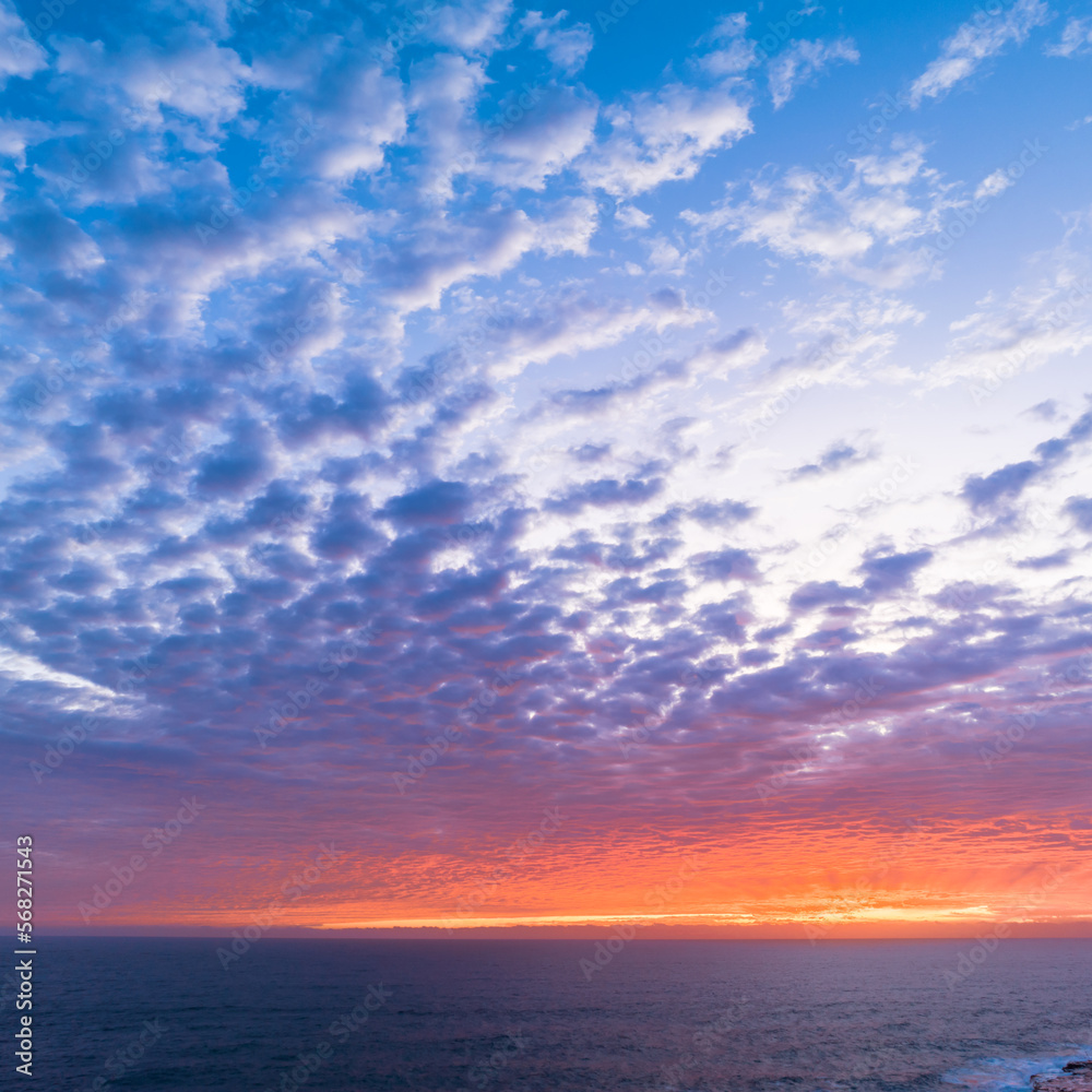 Sunrise sky over the sea with clouds and colour