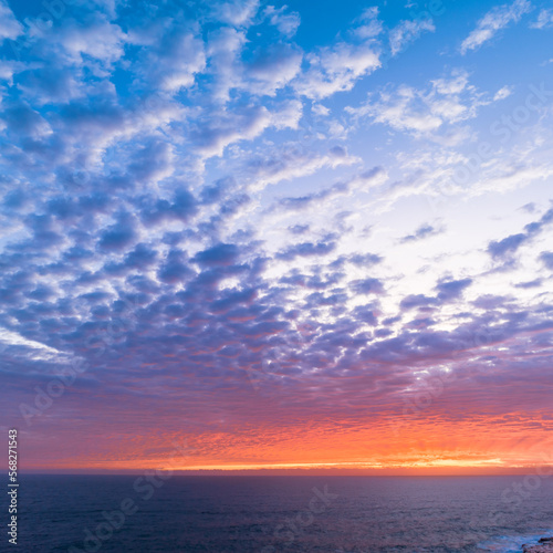 Sunrise sky over the sea with clouds and colour
