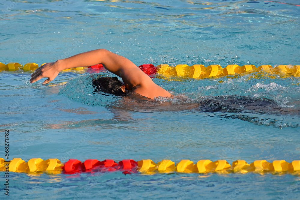 Sport man swimming in the pool at the sport complex.Professional Athlete Training for the Championship.Male Swimmer swimming in swimming pool.