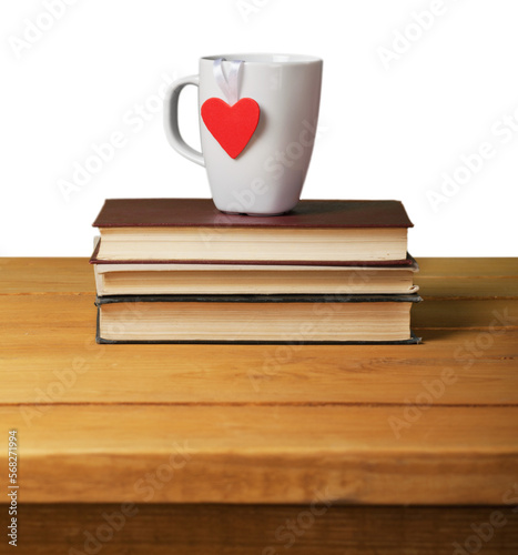 Coffee cup with the heart on vintage books