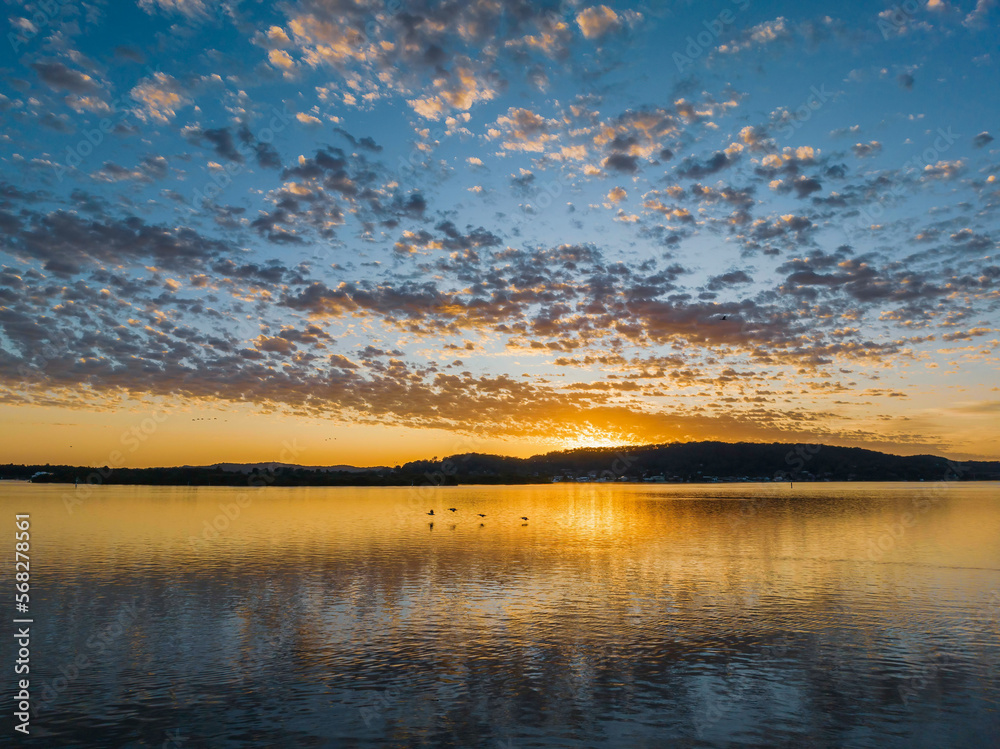 Pretty sunrise waterscape with low clouds