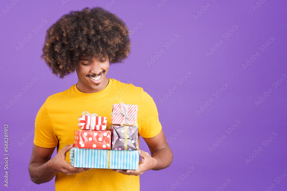 African man smiling with many gifts in the hands African man smiling with many gifts in the hands