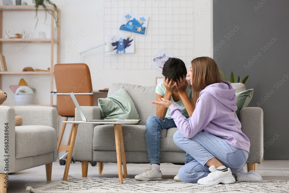 Upset little boy and his mother video chatting with psychologist at home Upset little boy and his mother video chatting with psychologist at home