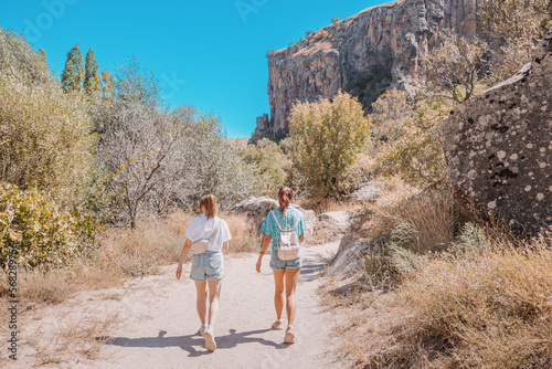 Tourists girls exploring and walking at popular travel attraction of Turkey and Cappadocia - Ihlara valley