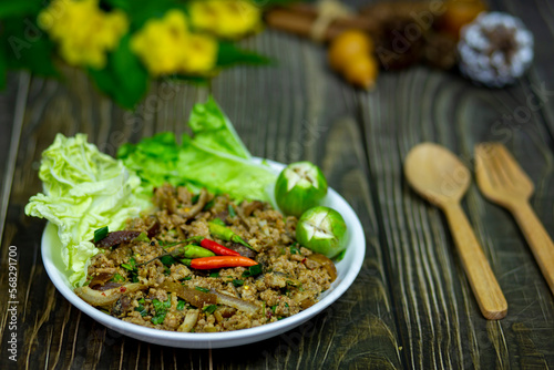 Thai esan food, spicy minced boar salad with fresh vegetables served on the dining table It's my lunch for today.