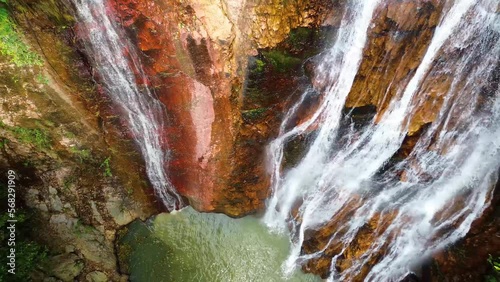 Beautiful waterfall in green forest, top view. Tropical in mountain jungle. Waterfall in the tropical forest. Shooting from a drone. 4k