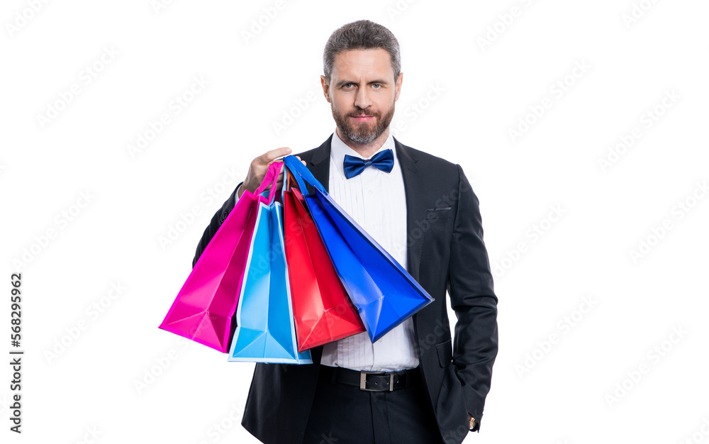 positive tuxedo man with shopping bag isolated on white background. tuxedo man after shopping. positive tuxedo man with shopping bag isolated on white background. tuxedo man after shopping.