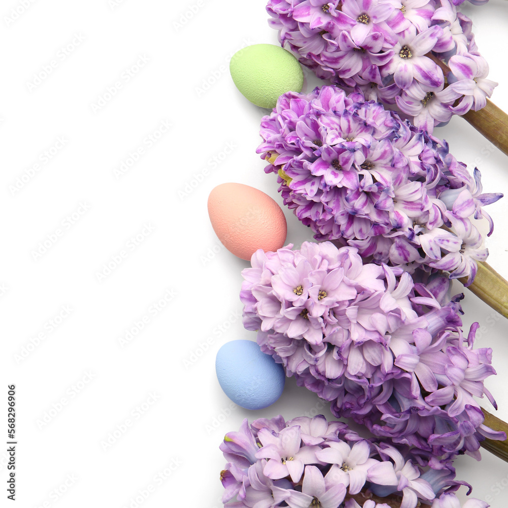 Fototapeta premium Beautiful hyacinth flowers and Easter eggs on white background