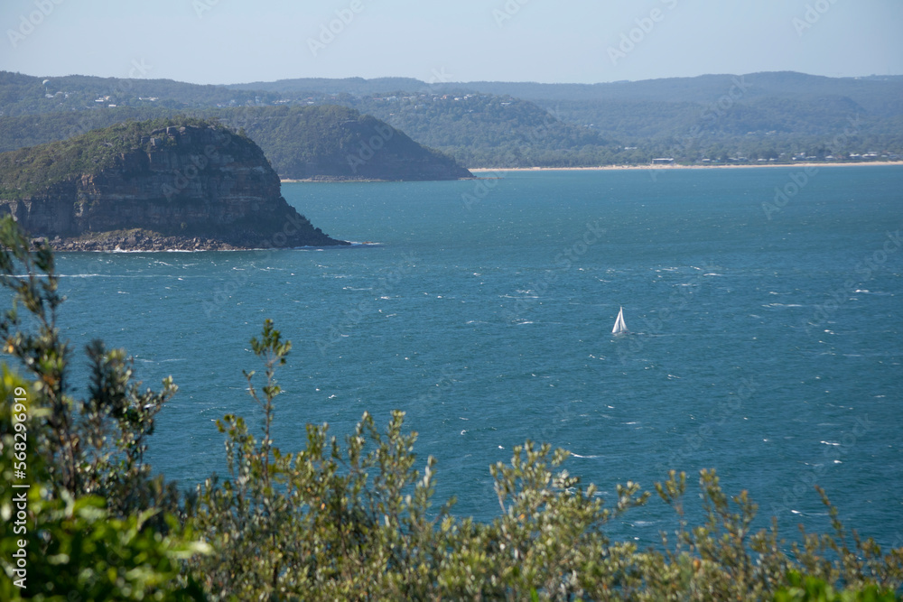 landscape with a sailboat sailing in the open sea with the islands and mountains around it landscape with a sailboat sailing in the open sea with the islands and mountains around it