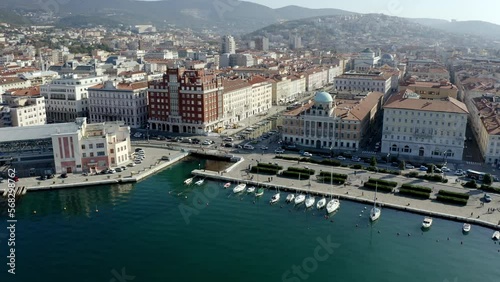 aerial drone shot of trieste city center from the sea on the canal grande ponterosso with hills in background photo