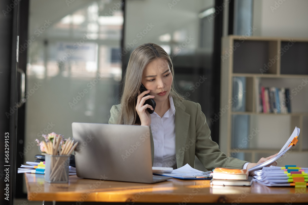 Asian businesswoman are stressed and tired from work sitting at desk in the office, feeling sick at work, stress from work. Asian businesswoman are stressed and tired from work sitting at desk in the office, feeling sick at work, stress from work.