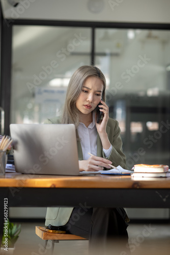 Asian businesswoman are stressed and tired from work sitting at desk in the office, feeling sick at work, stress from work. 