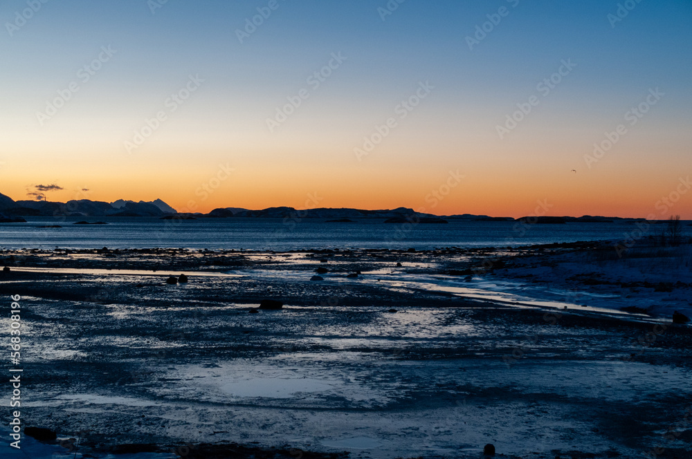 An orange glow of the extensive golden hour in arctic Northern Norway, during winter. An orange glow of the extensive golden hour in arctic Northern Norway, during winter.