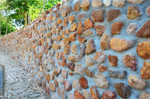 Building wall structure and architecture concrete rock stone with cobblestone at parking in Kaeng Krachan Dam reservoir at Kaengkrachan National Park in Phetchaburi, Thailand photo