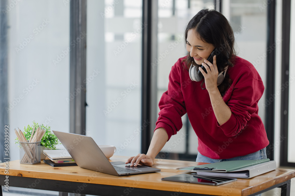 young asian business woman sitting and laptop in office workplace, business accounting and financial planning concept. young asian business woman sitting and laptop in office workplace, business accounting and financial planning concept.