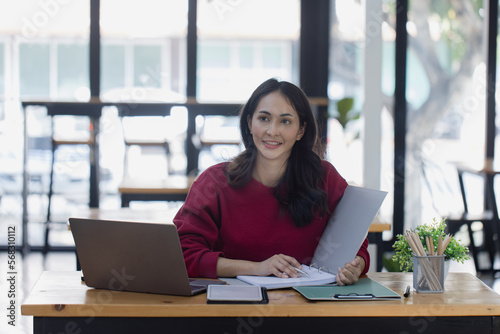 young asian business woman sitting and laptop in office workplace, business accounting and financial planning concept.