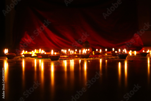 Beautiful diwali lighting, selective focus, Clay diya lamps lit during Diwali Celebration.