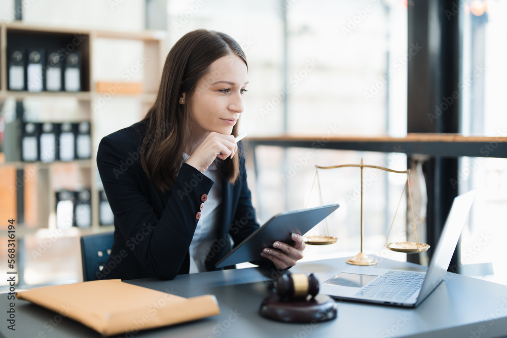 Portrait of a Asian woman lawyer studying lawsuit a for a client using tablet computer to work before going to court. Portrait of a Asian woman lawyer studying lawsuit a for a client using tablet computer to work before going to court.