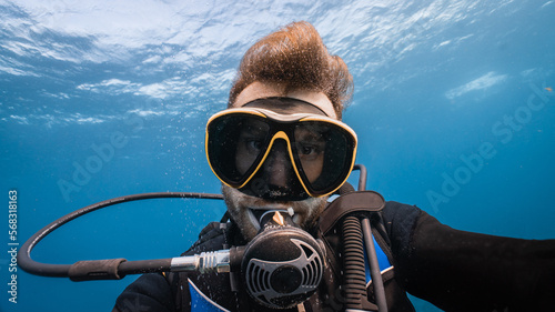 very close portrait of a diver underwater