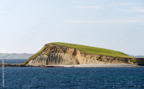 Inish Broon Inishbroon island seen west from Curragh Beach at Rinvyle Point, north Connemara, Ireland. Showing gully erosion and quartz pebble beach photo