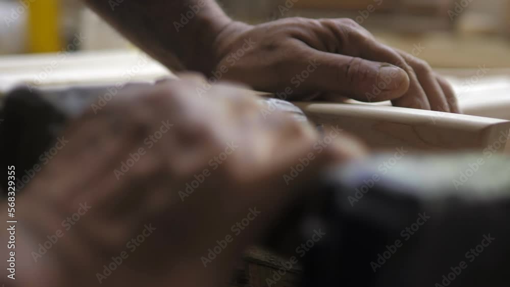Slow motion. A professional carpenter takes a close-up of the details of furniture made of wood together.Assembling furniture in a carpentry workshop. Wood products for home decor.Lifestyle Slow motion. A professional carpenter takes a close-up of the details of furniture made of wood together.Assembling furniture in a carpentry workshop. Wood products for home decor.Lifestyle
