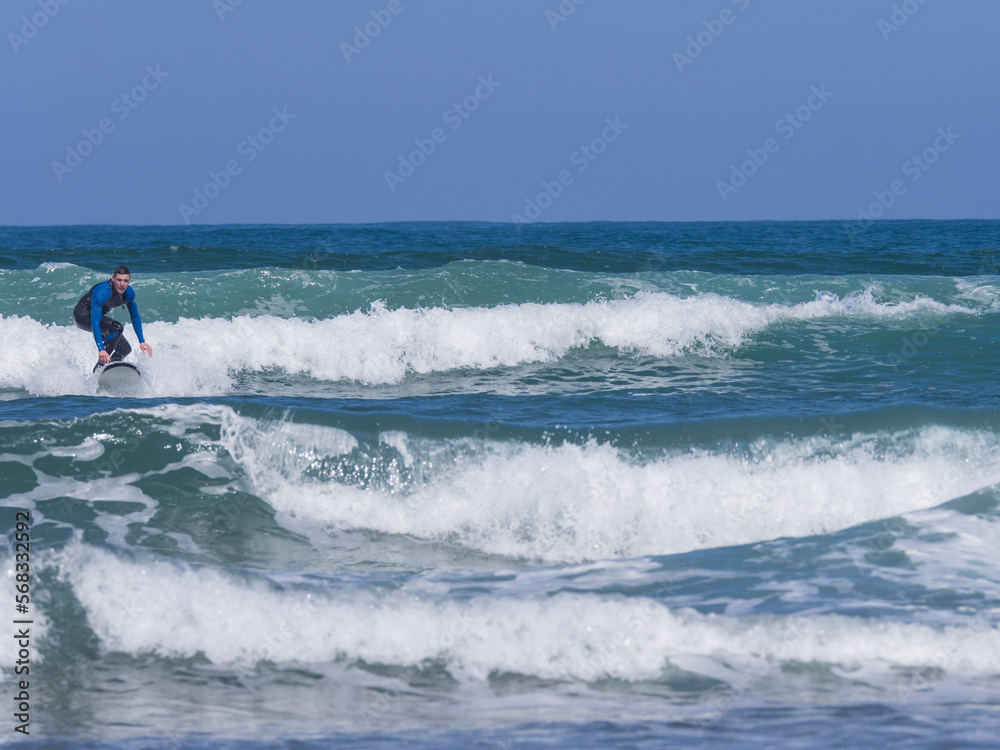 Young man surfing on Sopela Beach, Biscay, Basque Country, Spain Young man surfing on Sopela Beach, Biscay, Basque Country, Spain