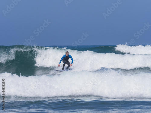 Young man surfing on Sopela Beach, Biscay, Basque Country, Spain photo