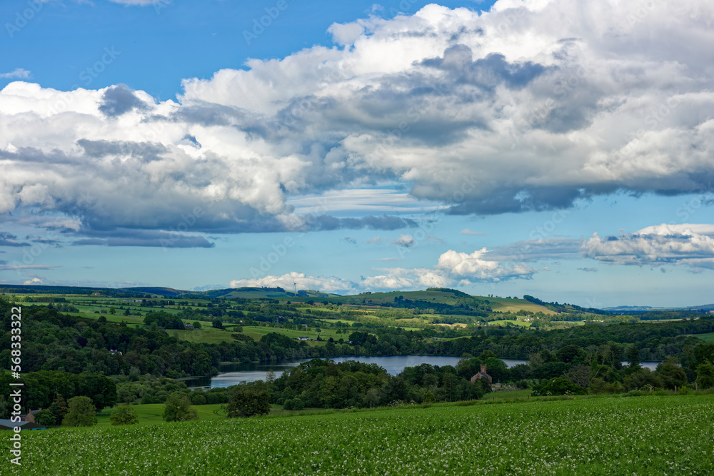 Looking down to Loch Clunie from the surrounding Hills with scattered Trees amongst the farmland of the surrounding Hills. Looking down to Loch Clunie from the surrounding Hills with scattered Trees amongst the farmland of the surrounding Hills.