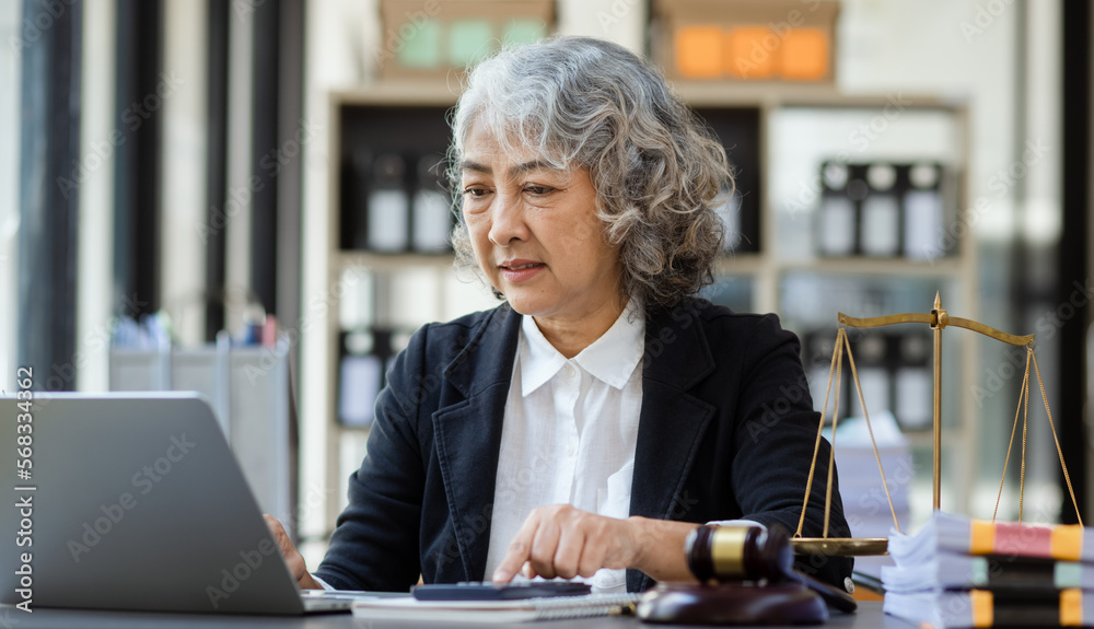 Asian lawyer woman working at law office desk, law firms, advice and justice concept. Asian lawyer woman working at law office desk, law firms, advice and justice concept.