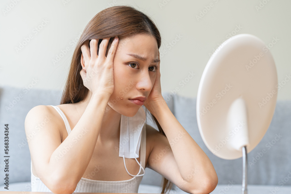 Expression worry asian young woman hand touching pustule around the chin and mouth, allergic when wear mask, makeup, show squeezing pimple spot from face. Beauty care, skin problem by acne treatment. Expression worry asian young woman hand touching pustule around the chin and mouth, allergic when wear mask, makeup, show squeezing pimple spot from face. Beauty care, skin problem by acne treatment.