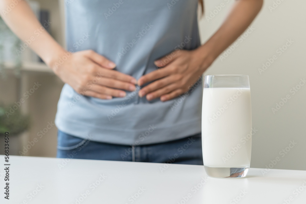 Foto de Pain, suffering asian young woman having a stomachache, abdominal pain or digestive