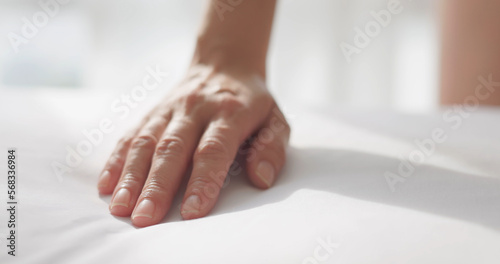 woman hand on bed