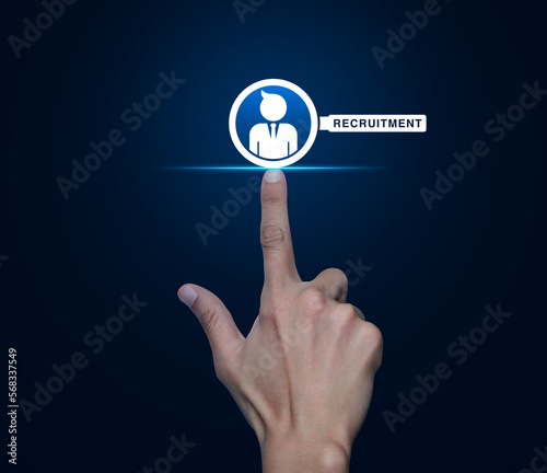 Hand pressing businessman with magnifying glass icon over blue background, Business recruitment service concept