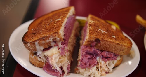 Ruben sandwich piled high with a side of fries close up